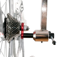 Alignment gauge threaded into the derailleur hanger of a road bike, next to the cassette
